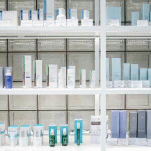 A clean and organized display of skincare products on shelves, perfect for beauty enthusiasts.