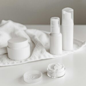 Elegant display of skincare products on a white surface, highlighting simplicity and purity.