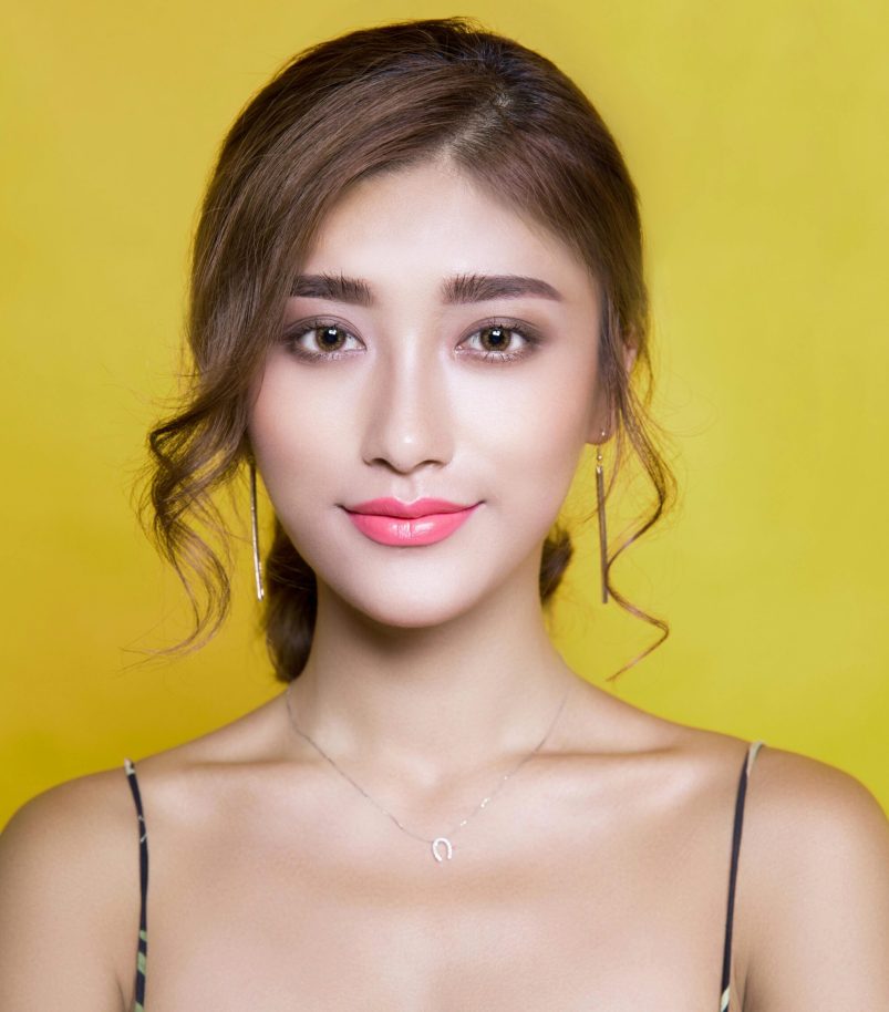 pexels-photo-415829-415829 Beautiful portrait of a woman with elegant hairstyle on a vibrant yellow background.